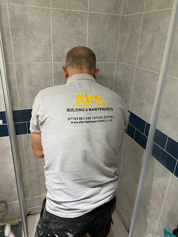 APS team member in shower installation