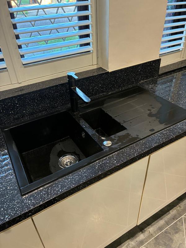 Black granite sink with double basin and chrome tap