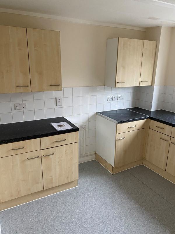 Cream kitchen units with black countertop