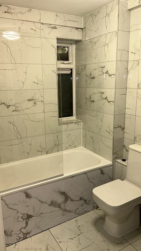 Luxurious marble-tiled bathroom with Calcutta marble effect