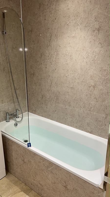 Marble-effect shower with glass enclosure