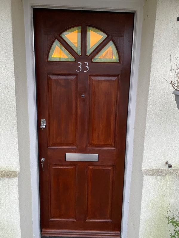 Red wooden door with yellow transom windows