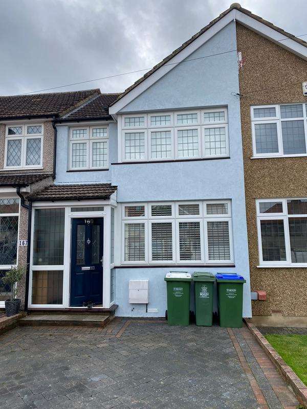 White rendered house with blue door
