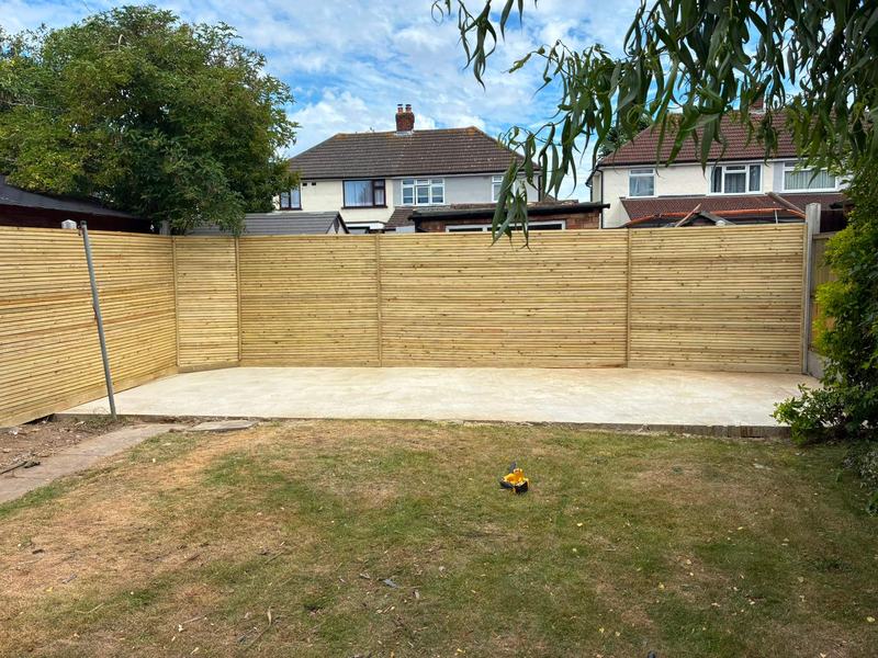 Wooden fence with new patio construction